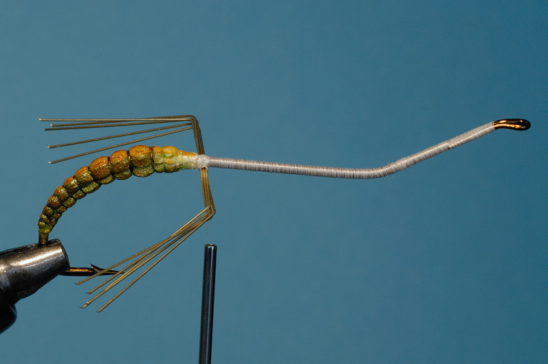 five pieces of fine brass wire secured to the hook to create the legs