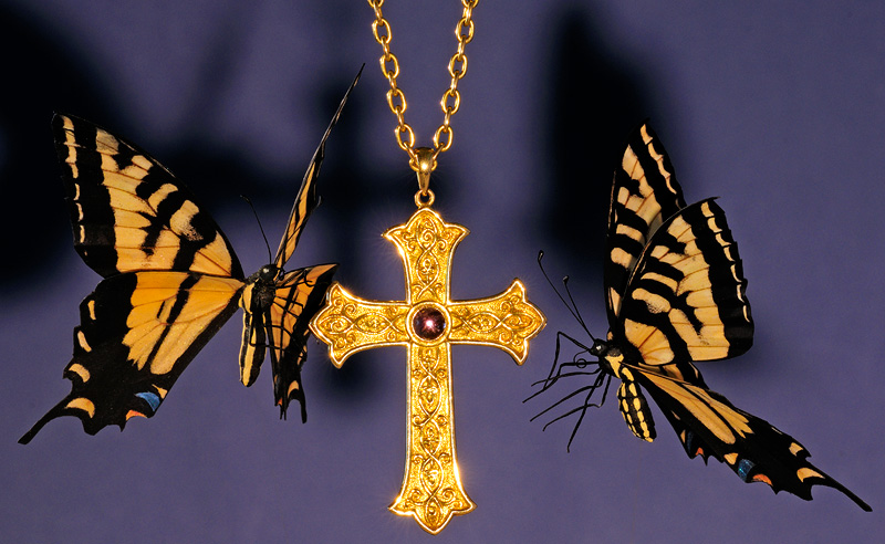 Tiger Swallowtail butterfly replicas and a gold Bishops cross